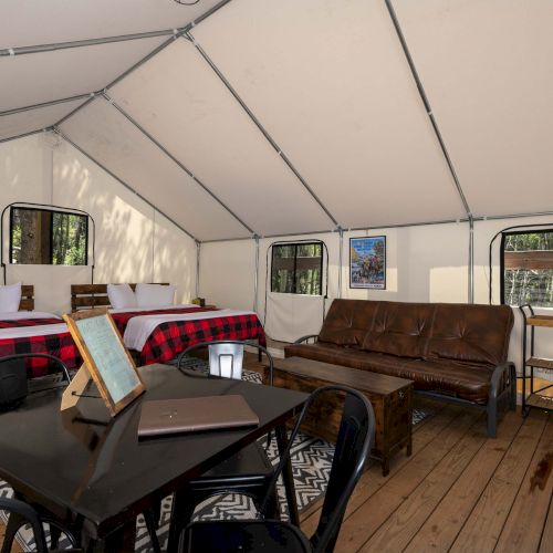 A cozy living room with a low table, cushions, and a cat on the upholstery; warm lighting and a few wall shelves. Top it at 140 characters, always ending the sentence.